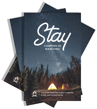 A mockup of the cover of the 2022 Stay - Camping in Manitoba